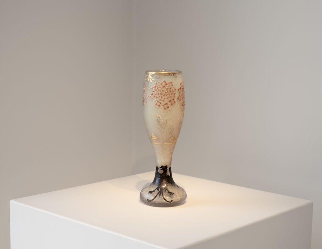 Daum Nancy Art Nouveau cameo glass vase with a frosted white ground, decorated in enamel with a flowering lilac tree and a black heraldic eagle on the foot.