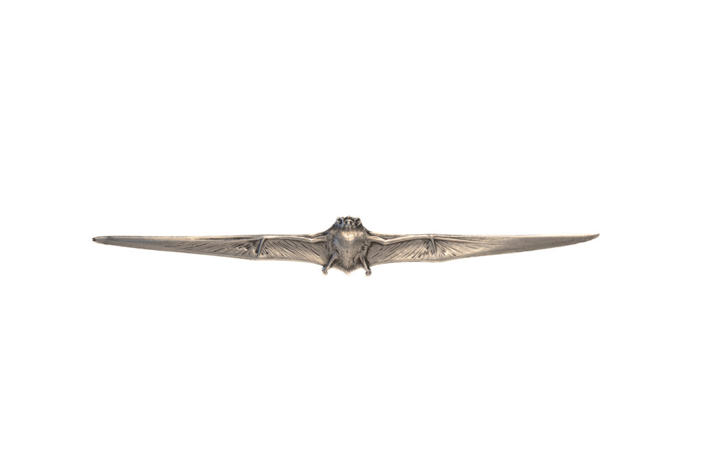 Victor Sabatier Art Nouveau silver letter opener in the form of a bat with outstretched wings, featuring finely detailed feather-like engraving and a sculptural central body. French, circa 1900.